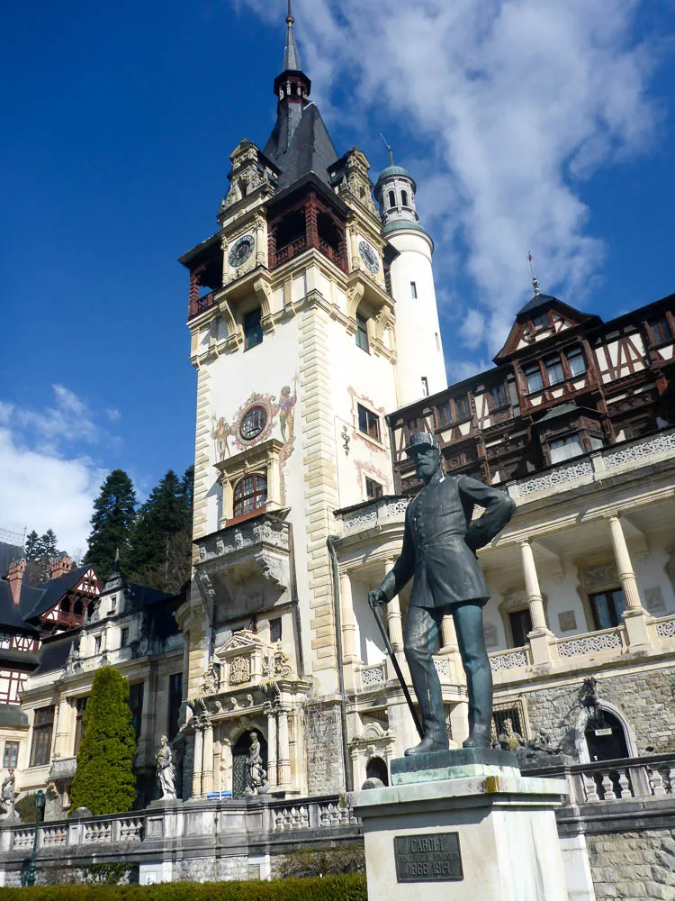 peles castle and statue